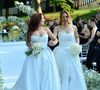 Mari Fernandez e Júlia Ribeiro subiram ao altar com vestidos brancos, em looks clássicos e românticos