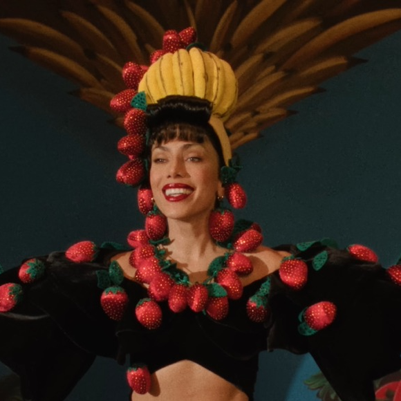 Anitta e Carmen Miranda pertencem a gerações diferentes, mas compartilham uma trajetória de internacionalização da cultura brasileira por meio da música e da imagem