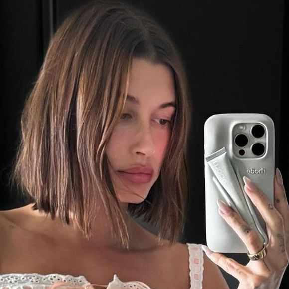 Hailey Bieber revela possíveis gatilhos: “A pele sempre fica inflamada quando viajo muito, tenho sono insuficiente, uso hormônios, FPS errado, produtos novos, estresse”.