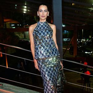 Fernanda Motta: surgiu com um conjunto de duas peças em bordado de paetês multicoloridos com predominância de tons azul-marinho, prata e dourado em padrão geométrico. A parte de cima é uma regata de gola alta estilo frente-única, combinada com saia de comprimento midi/longo de caimento reto. Nos pés, usa sandálias de salto fino decoradas com pedrarias