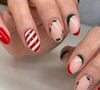 Unhas Natalinas com nail art que mistura cerejas e listras