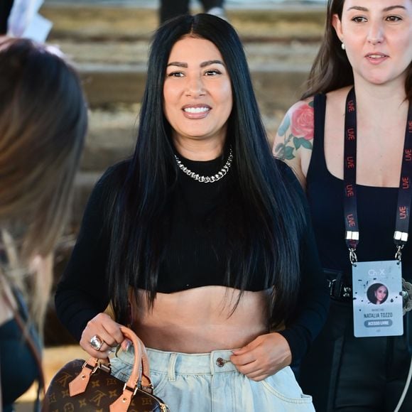 No último domingo (12), Simaria escolheu um look com top cropped preto, minissaia jeans volumosa e botas de cano alto