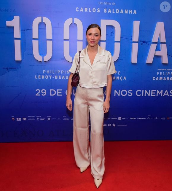 Alice Wegmann apostou em um conjunto acetinado de camisa cropped e calça pantalona em tom champanhe, complementado por bolsa vinho e scarpins claros