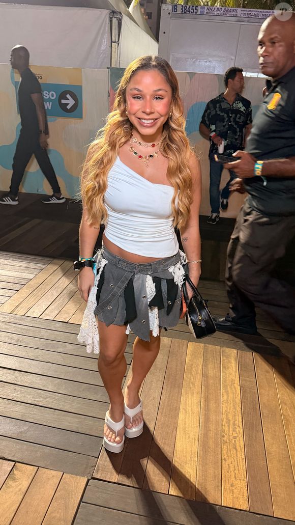 A ginasta Flávia Saraiva escolheu uma saia jeans diferentona e combinou a peça com um cropped branco de apenas uma alça