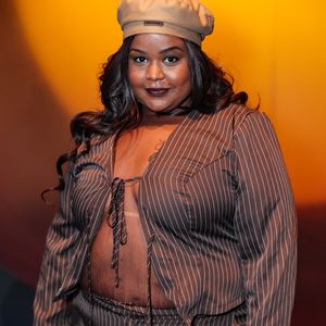 A cantora MC Carol esbanjou atitude com um conjunto de alfaiataria desconstruída em risca-de-giz marrom. O look é composto por uma calça de corte reto e um blazer cropped amarrado frontalmente por laços finos, deixando o abdômen à mostra em uma proposta audaciosa e moderna