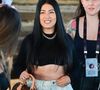 Simaria escolheu um look com top cropped preto, minissaia jeans volumosa e botas de cano alto