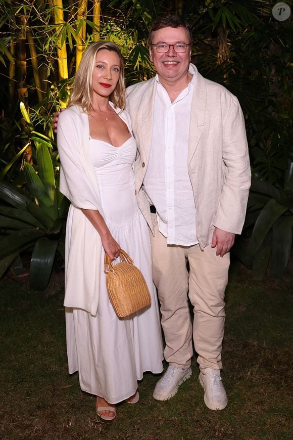 Vanessa Bueno e João Emanuel Carneiro: Ela usou vestido midi branco de decote coração franzido com echarpe e bolsa de palha; ele optou pelo conforto com blazer de linho bege, camisa branca por fora da calça clara e tênis esportivo