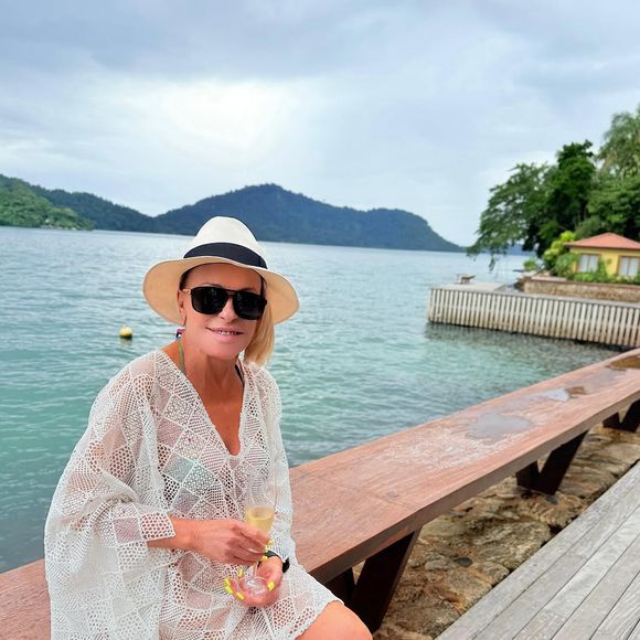 Na viagem, Ana Maria Braga posou usando um biquíni verde e cobrindo seu corpo com uma saída de praia em crochê cru