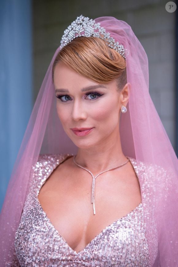 O rosa também pode ocupar o lugar de destaque no look de casamento, como mostrou Mariana Ximenes na novela 'Amor Perfeito'. Em 2023, a atriz usou um vestido de noiva brilhante com véu longo rosa para interpretar Gilda na cerimônia com Orlando, vivido por Diogo Almeida. Para quem planeja uma celebração fora do óbvio, o figurino serve de inspiração para explorar cores, brilho e acessórios coordenados