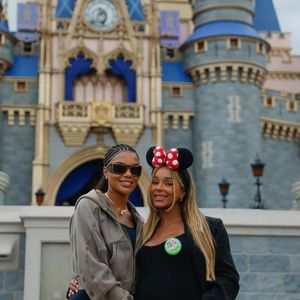Com o castelo da Cinderela ao fundo, Brunna Gonçalves e Ludmilla posam abraçadas no parque Magic Kingdom; a dançarina exibe o barrigão da primeira filha do casal, Zuri