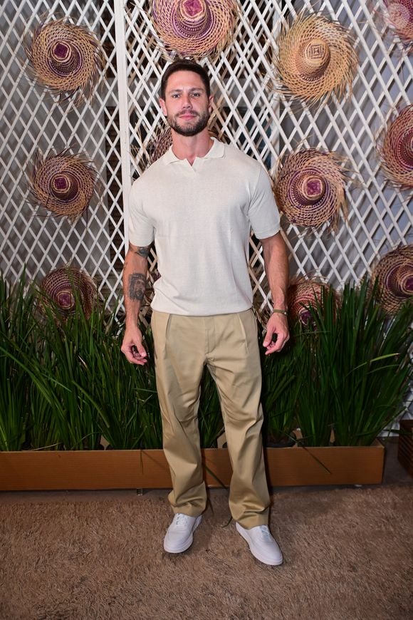 Jonas Sulzbach optou por um visual casual alinhado ao combinar uma camisa polo de malha texturizada em tom off-white com uma calça de alfaiataria bege de pregas frontais e caimento solto. O ex-BBB arrematou o look com tênis brancos de design clean e uma pulseira verde discreta