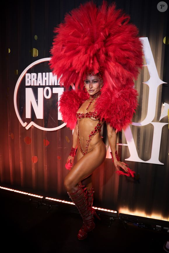 Sabrina Sato colocou a ousadia para jogo em um look vermelho mínimo e repleto de plumas na cabeça e ombros