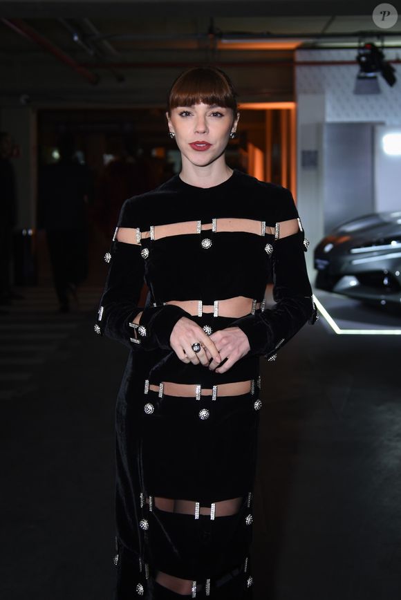 Alice Wegmann apostou em um vestido preto de veludo repleto de recortes simétricos que revelam a pele de forma calculada e provocativa. As aberturas, conectadas por fivelas cravejadas de cristais, criam um efeito belíssimo