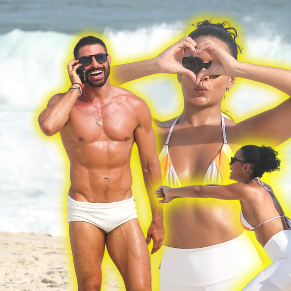 'Vale Tudo' na praia: Maria de Fátima no remake da Globo, Bella Campos combina legging branca e biquíni em gravação com Cauã Reymond