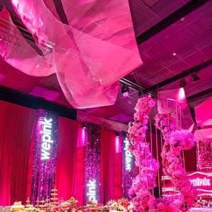 O logotipo da WePink aparece iluminado no painel de LED instalado no palco principal da festa