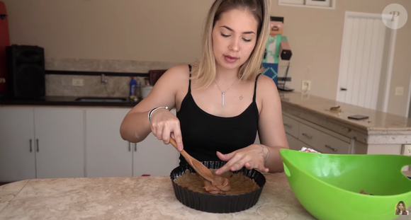 Com a metade da massa na forma, coloque uma camada generosa de doce de leite, que servirá como recheio