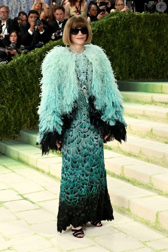A anfitriã Anna Wintour comparece ao Met Gala 2026, nesta segunda-feira (4), com um look de plumas em tom azul-turquesa que remete ao visual usado por ela em 2019, desta vez reinterpretado em uma versão mais clara e alinhada ao tema 'Costume Art', no Metropolitan Museum of Art