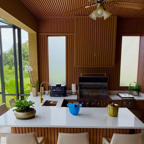 A área externa da mansão de Rick Sollo conta com jardim bem cuidado, piscina coberta e espaço gourmet com churrasqueira. A residência foi apresentada pelo cantor sertanejo e a esposa, Geralda Carvalho, nas redes sociais