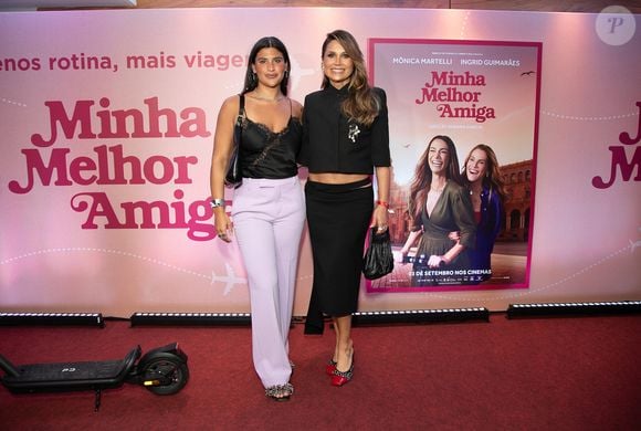 Flávia Alessandra, a Fábia de Quem Ama Cuida, apostou em um look preto elegante para prestigiar a estreia de Minha Melhor Amiga. A atriz combinou cropped de mangas curtas e ombros estruturados com saia longa de cintura baixa, recorte no quadril e fenda discreta, finalizando a produção com broche maximalista e sapato bicolor de poás e bico vermelho