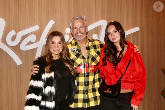 Caçula de Flávia Alessandra e Otaviano Costa, Olívia apostou em referências do streetwear ao combinar jaqueta cropped vermelha, calça de cintura alta e a clássica bolsa saddle da Vivienne Westwood no Rock in Rio