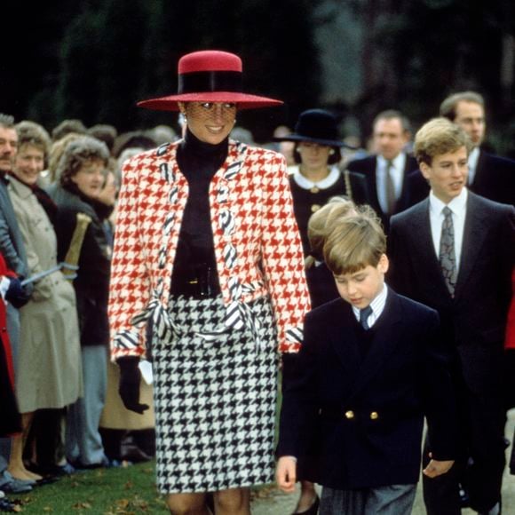 Princesa Diana apostou em um conjunto de terno e saia da Moschino, com estampa pied-de-poule em vermelho e branco, no batizado da Princesa Eugenie, em dezembro de 1990. O scarpin bicolor, com biqueira vermelha vibrante, também se destacou na produção e reforçou a elegância característica de seu estilo noventista